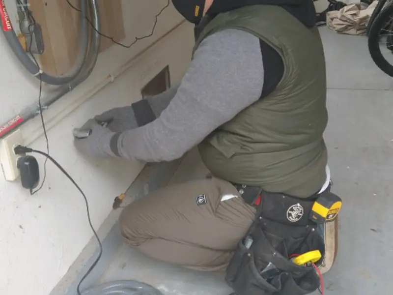 Electrician performing outlet wiring in a Neshannock garage